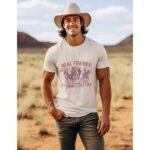 Man wearing Frontier Rogue Real Friends Rob Banks Together graphic tee in outdoor western setting