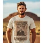 Man wearing Frontier Rogue Frank James Wanted Poster graphic tee in outdoor setting