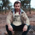 Man wearing Frontier Rogue Tough Times Make Tough People tee in outdoor setting