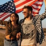 Man wearing Frontier Rogue True Feeling Can't be Bought Can't be Faked tee with girl and American flag