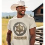 Man wearing Frontier Rogue Bass Reeves US Marshal graphic tee in outdoor ranch setting