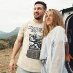 Man wearing Frontier Rogue Daniel Boone graphic tee in outdoor setting with woman and van