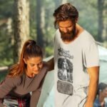 Man wearing Frontier Rogue Davy Crockett graphic tee in outdoor setting with woman